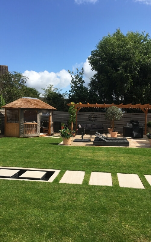 This garden renovation project uses stained white pressure treated fence panels.